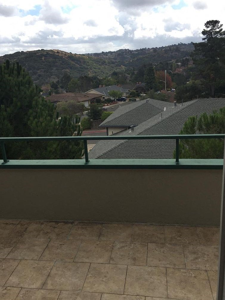 A balcony with a view of a mountainous landscape.
