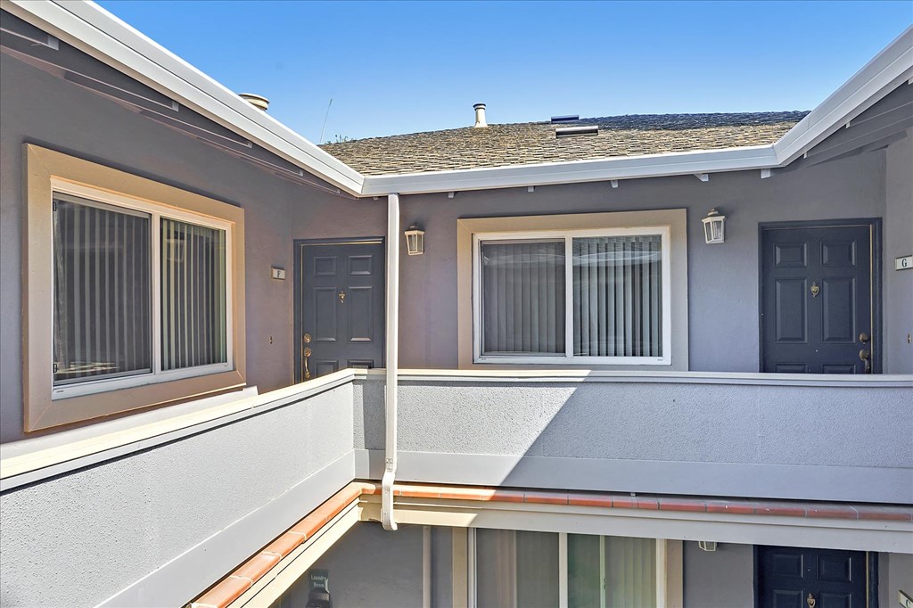 A balcony of a house with a view of the sky.