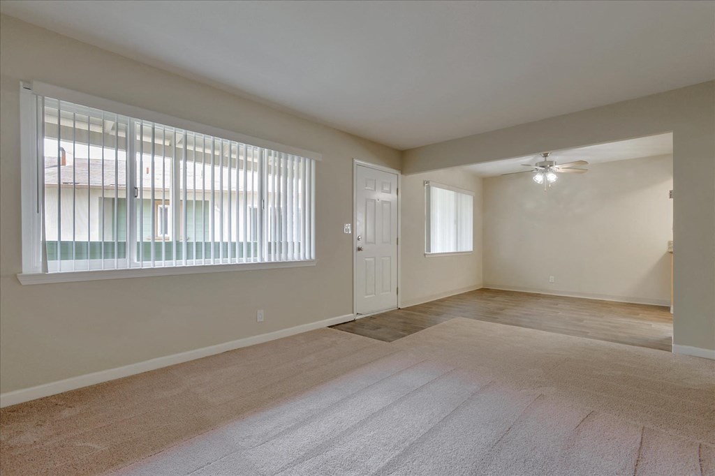 the spacious living room and dining room in a new home