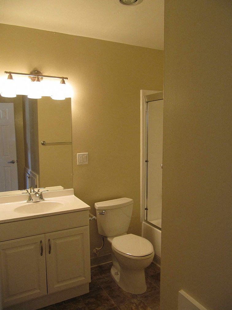 a bathroom with a toilet and a sink and a shower