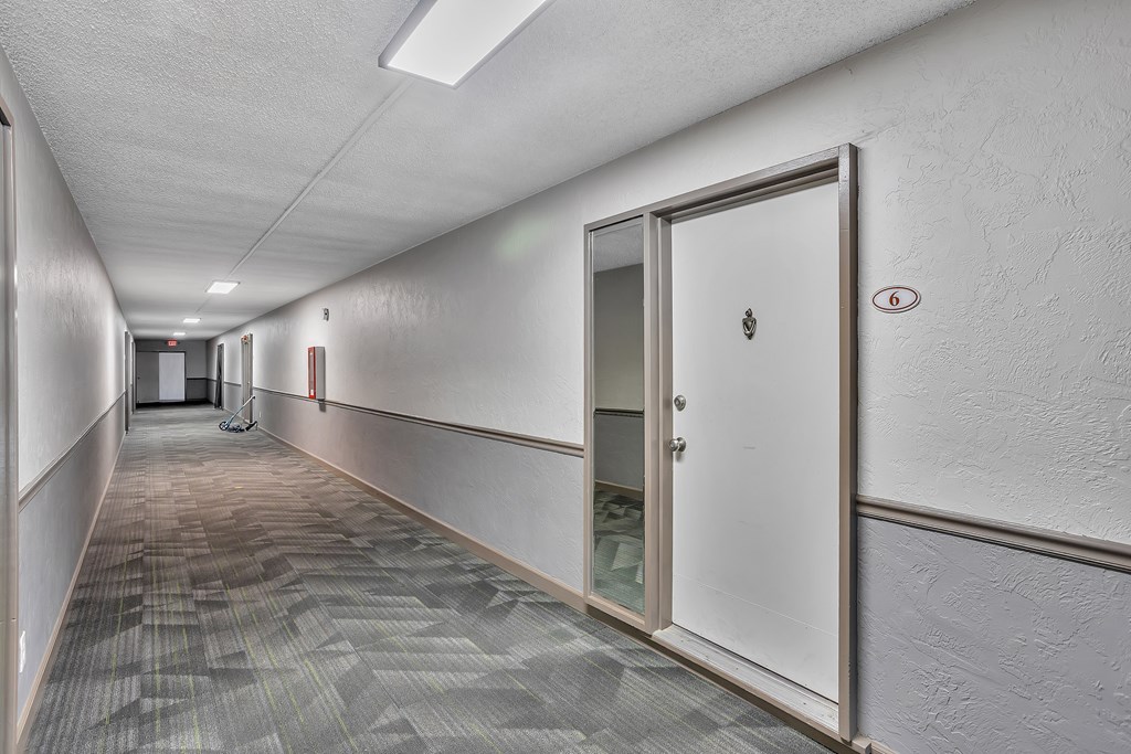 A long hallway with a door on the right.