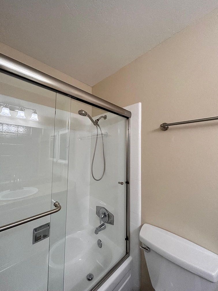 a bathroom with a shower and a toilet