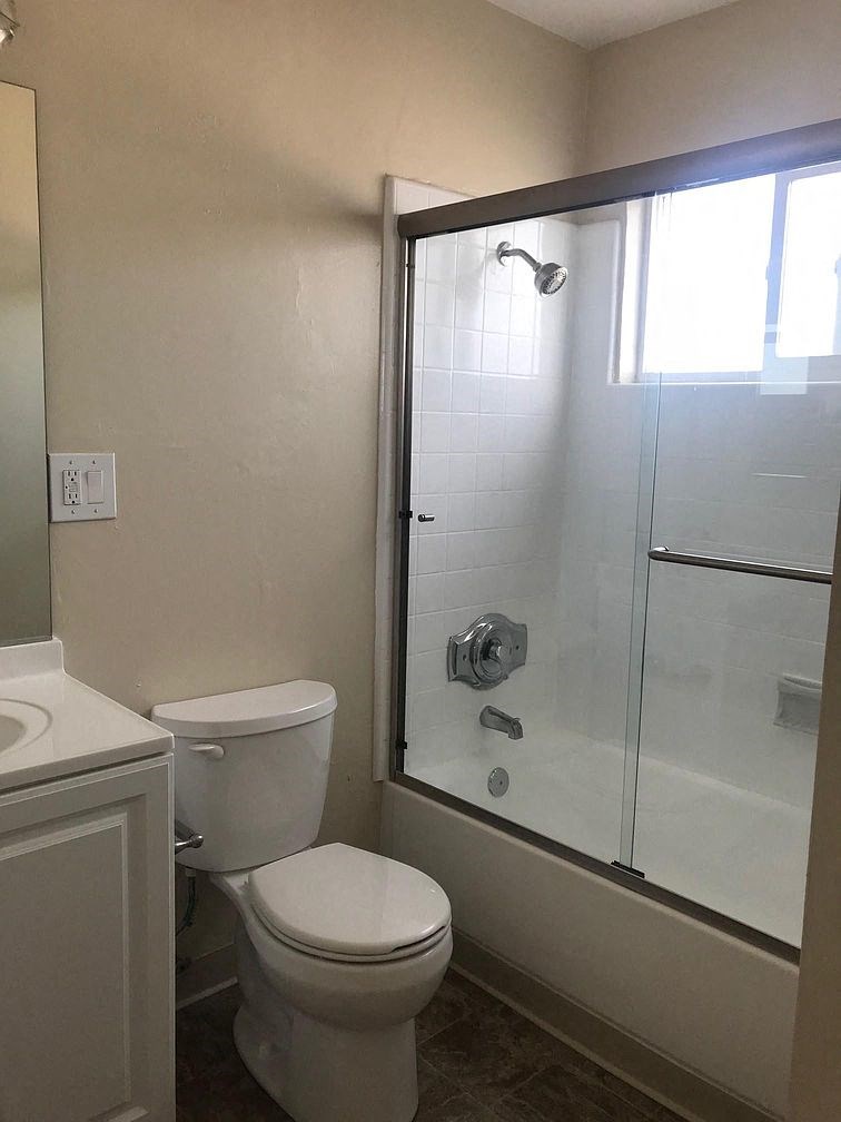 a bathroom with a toilet and a shower