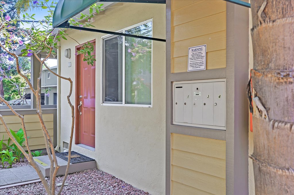 the front entrance of a house with a red door