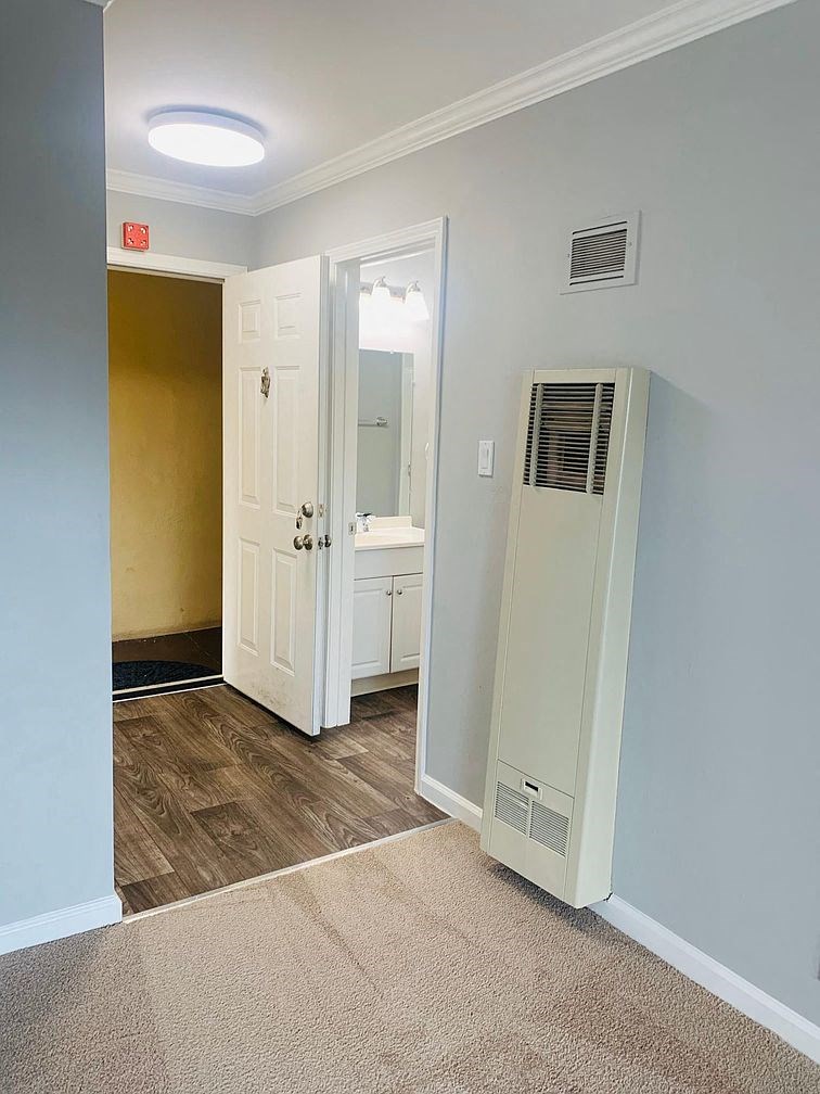 A white door is open to a bathroom.