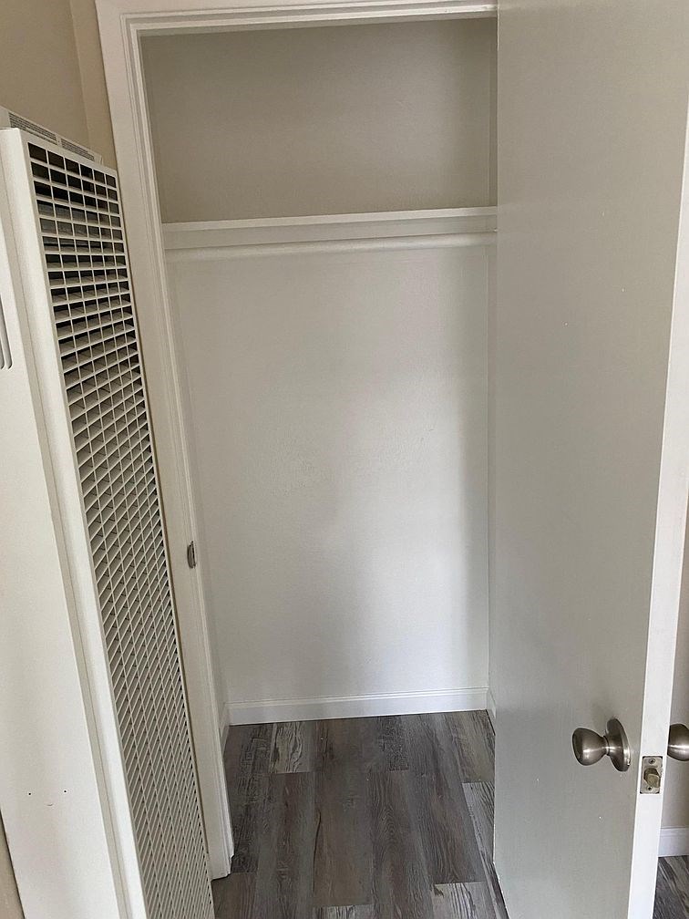 A white door with a handle and a white wall.