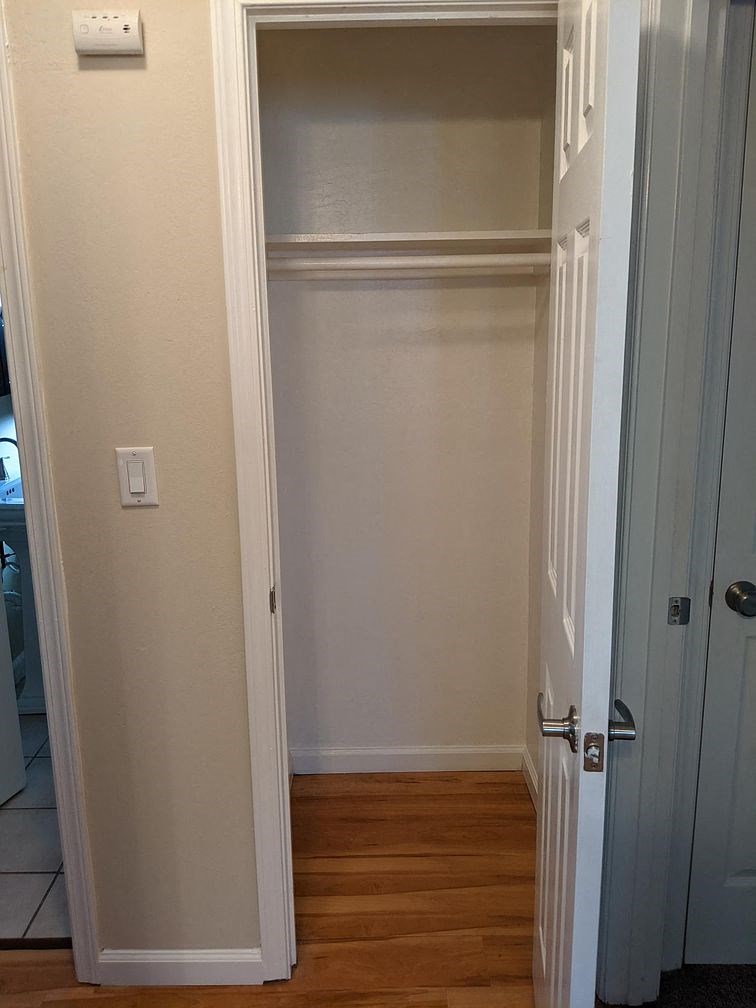 A white door is open to a hallway.