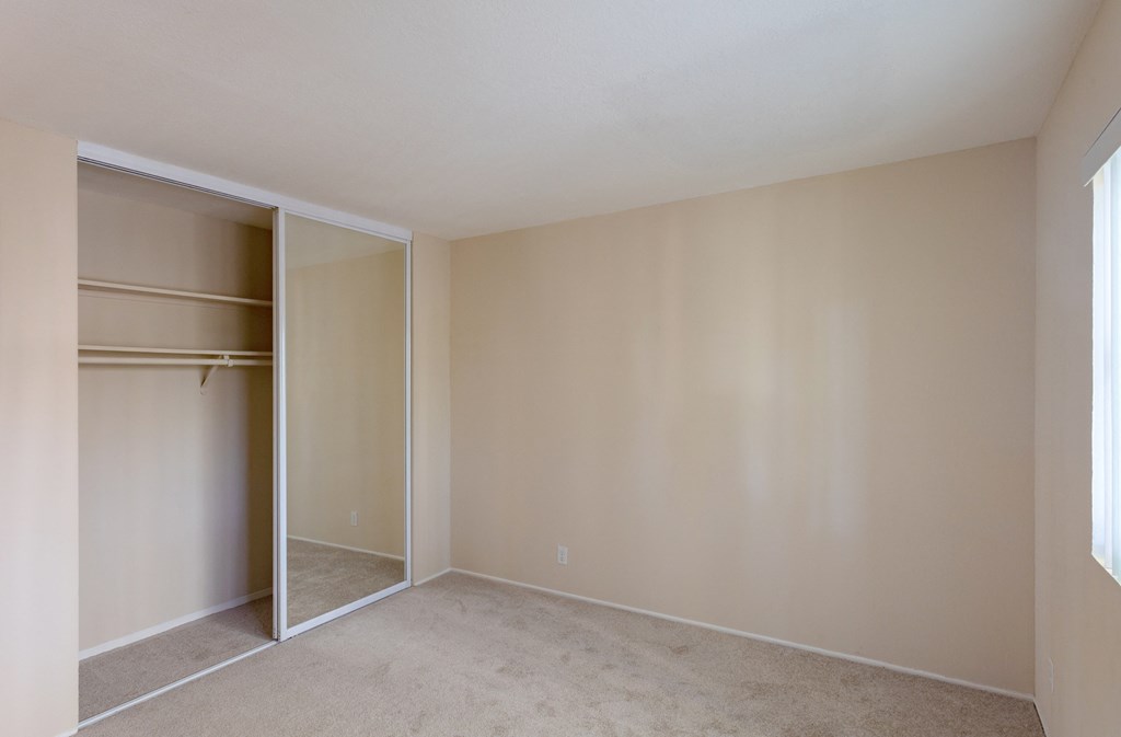 an empty living room with a closet in it