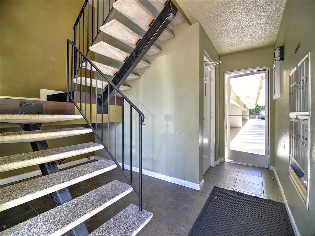 a staircase leading up to a house with a door