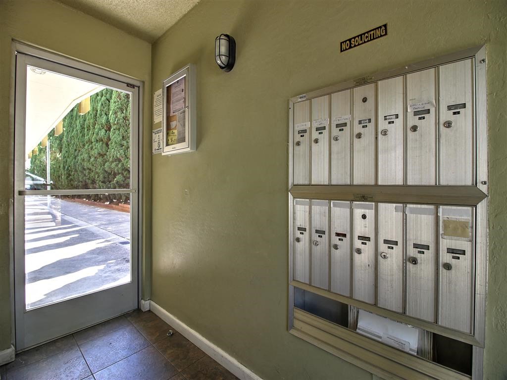 a locker room with lockers and a glass door