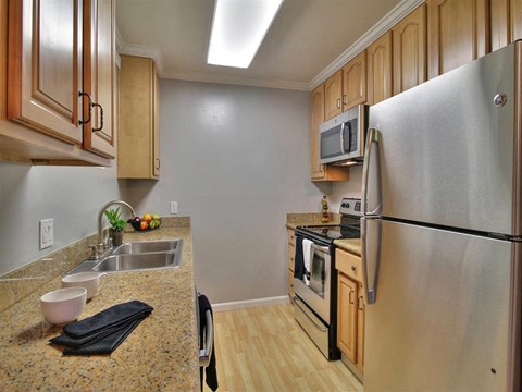 a kitchen with stainless steel appliances and granite counter tops