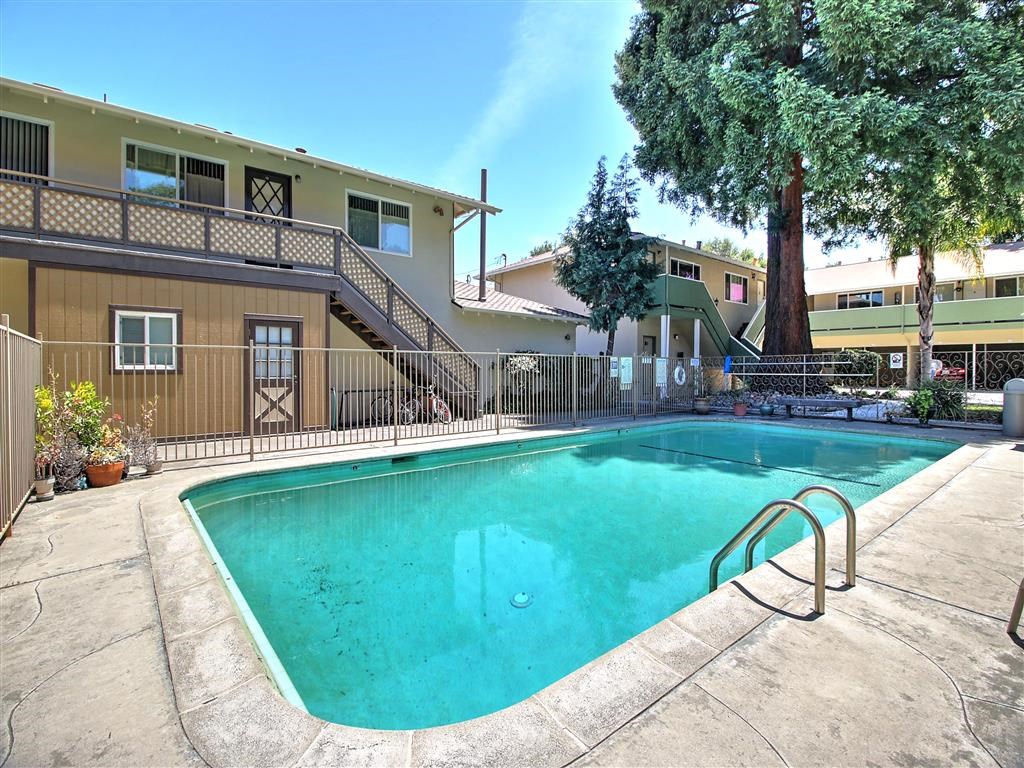 a swimming pool with a building in the background