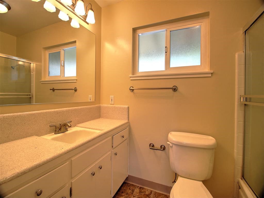 a bathroom with a toilet and a sink and a mirror