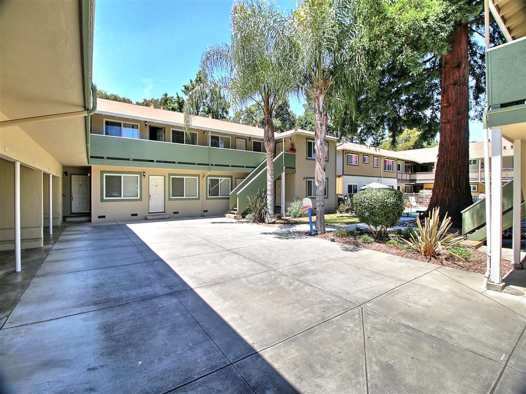 a courtyard in front of a building with trees