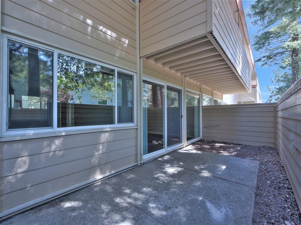 the entrance to a home with a patio and glass doors