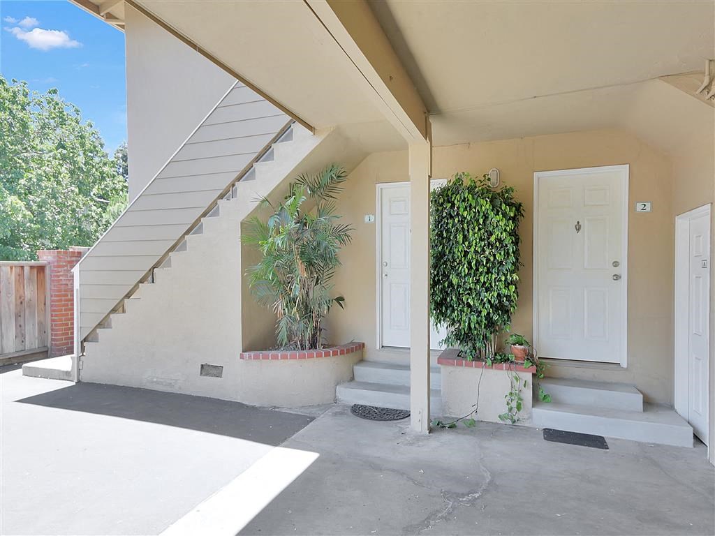 the entrance to a building with stairs and a white door