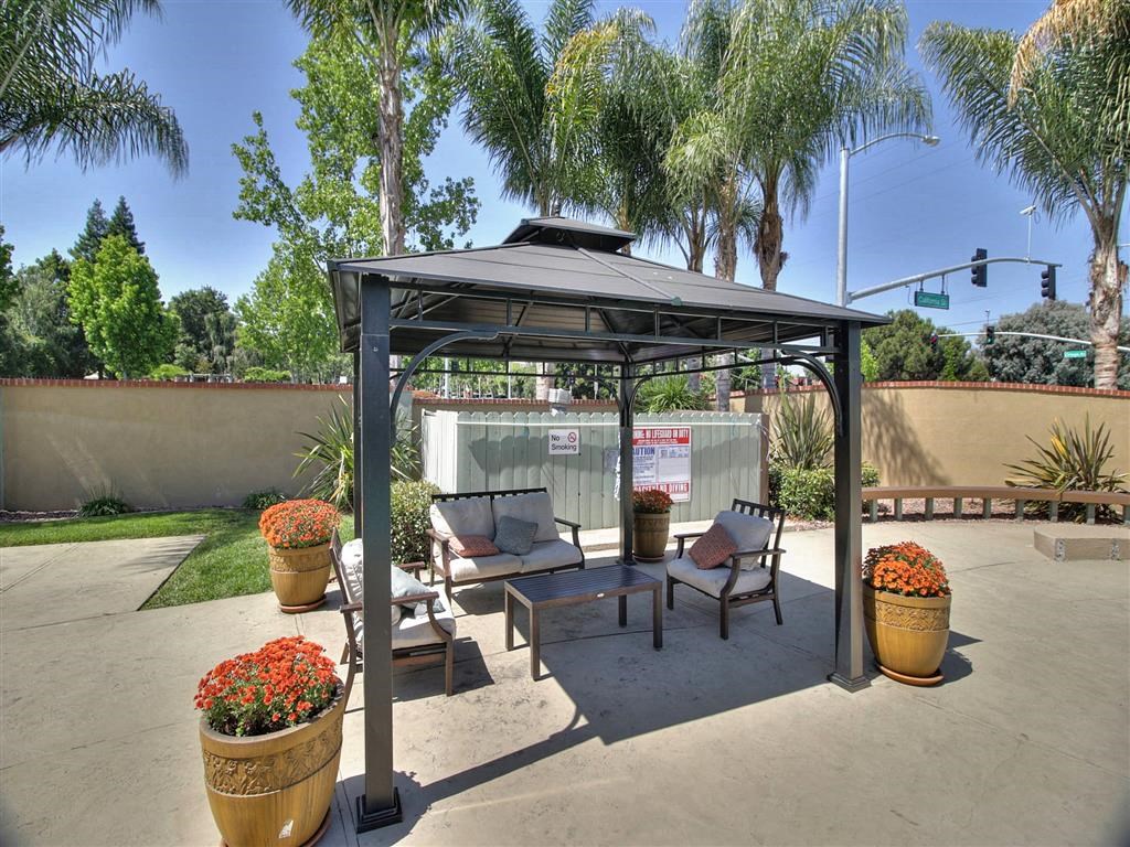 shaded seating area next to pool at The Arbors at Mountain View, Mountain View