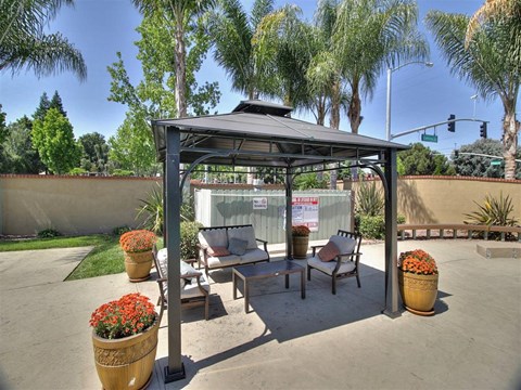 shaded seating area next to pool at The Arbors at Mountain View, Mountain View