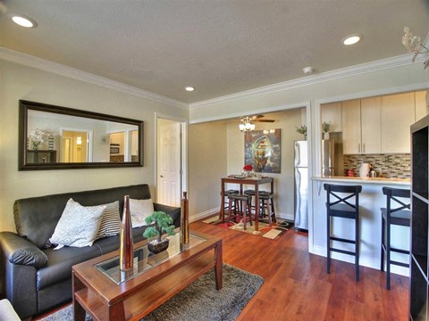 a living room and kitchen with a couch and a table