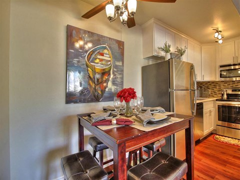 a kitchen and dining room with a table and chairs