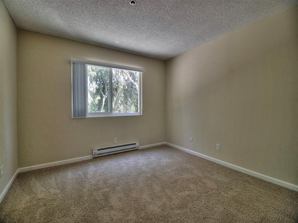Bedroom with window and wooden floor at Boardwalk, California