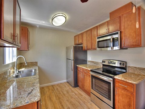 a kitchen with stainless steel appliances and granite counter tops