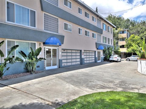 a building with a driveway and a parking lot