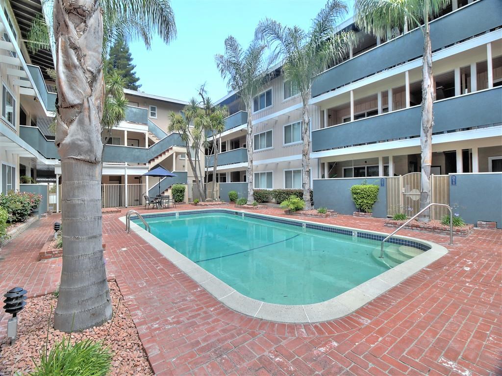 a swimming pool in front of an apartment building