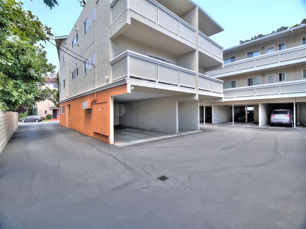 a parking garage in front of an apartment building