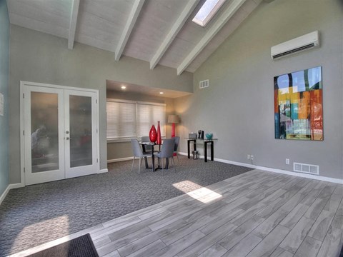 a living room with a sliding glass door and a table and chairs