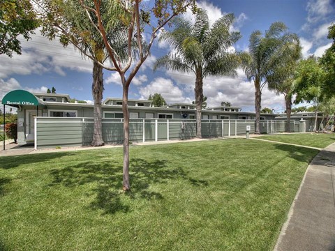A green building with a sign that says Rental Office.