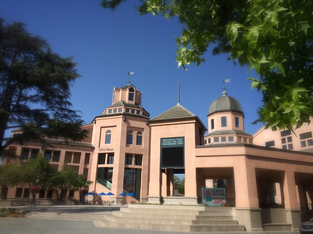 a large building with three towers in front of a blue sky