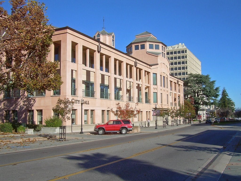 a red car parked in front of a building on a street