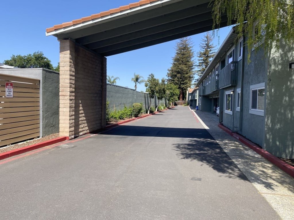 A road with a no parking sign on a pole.