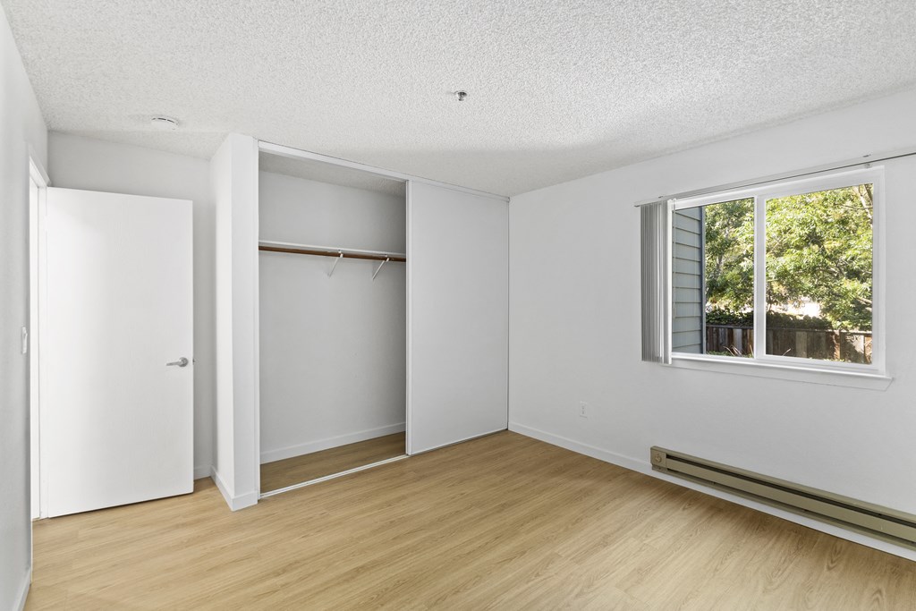 an empty room with white walls and a window