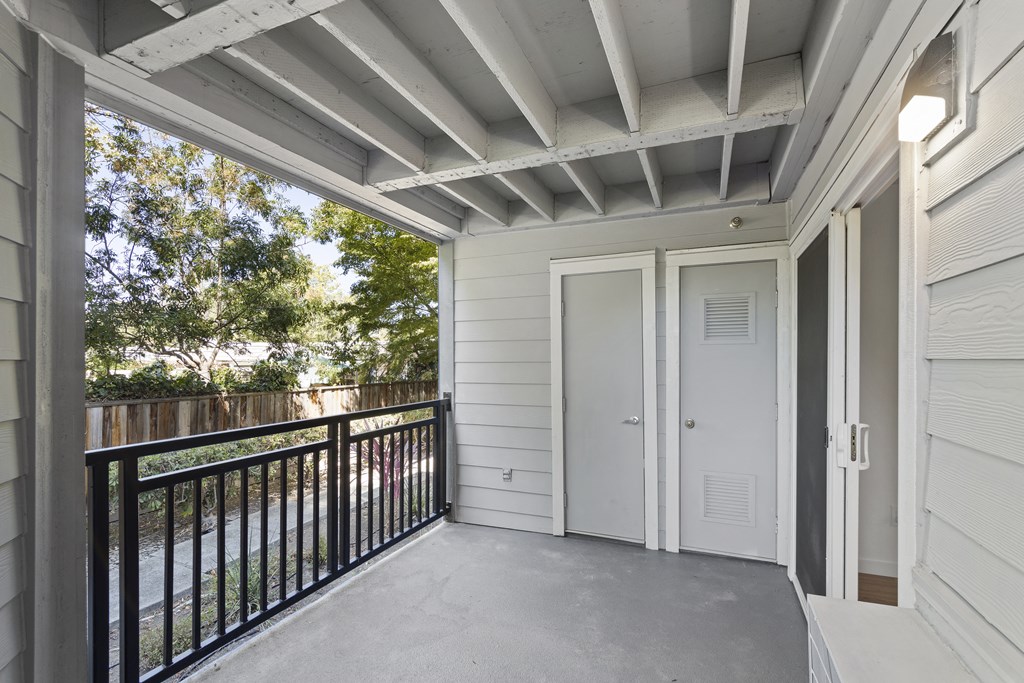 the view from the balcony of a home with a balcony door and a balcony railing