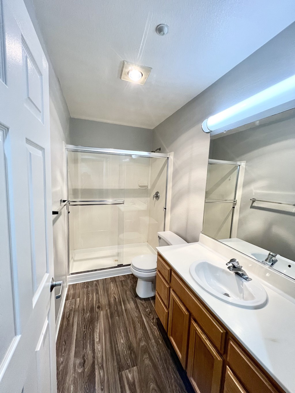 A bathroom with a white sink and a toilet.