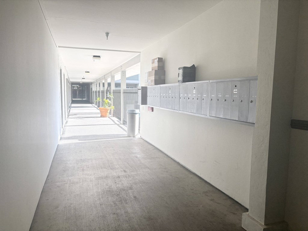 A long hallway with a row of lockers on the right side.