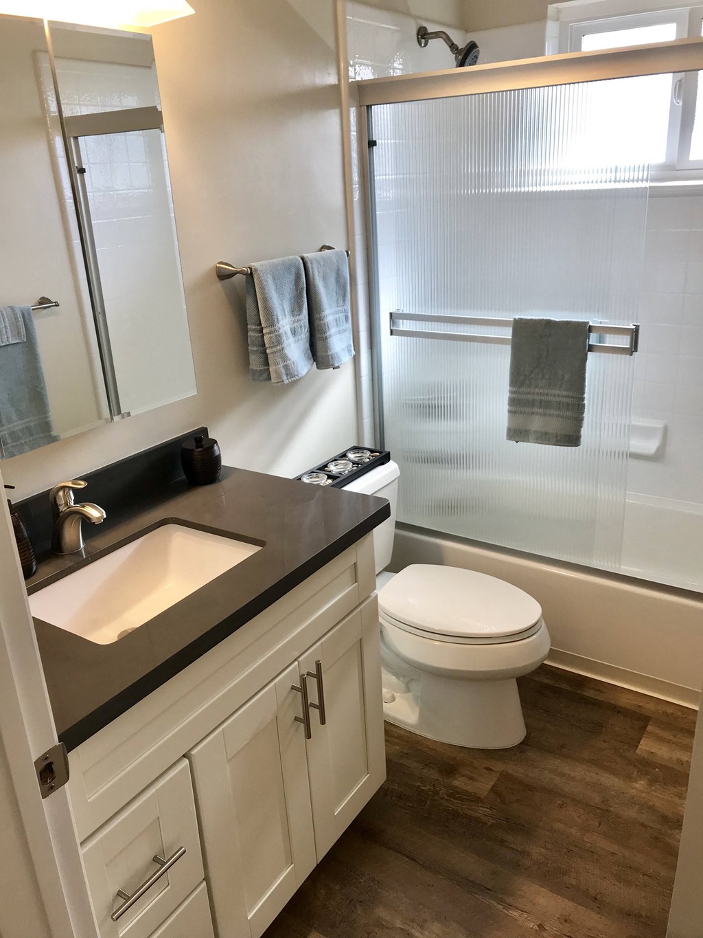 a small bathroom with a sink toilet and shower