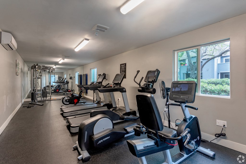 the gym has plenty of cardio equipment at the enclave at university heights apartments