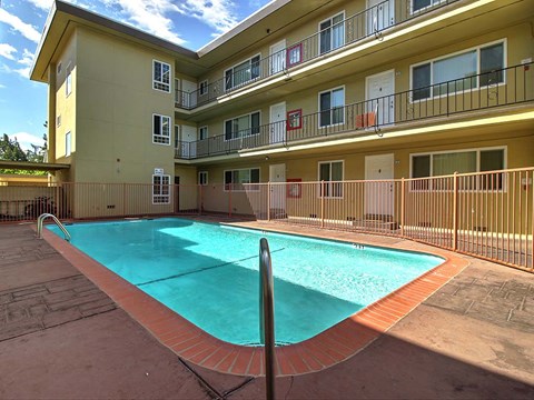 a swimming pool in front of an apartment building