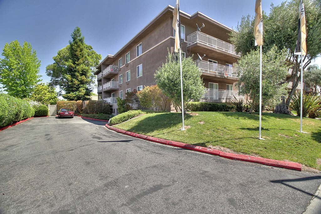 Street side view with Trees surrounding the building at The Luxe, Santa Clara, CA, 95051
