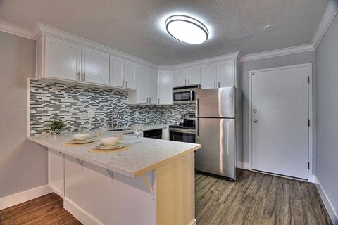 a kitchen with a counter top and a refrigerator