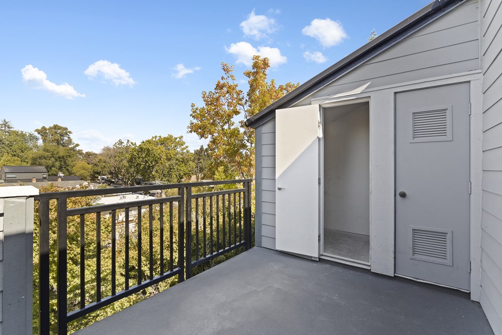 a balcony with a fence and a garage door