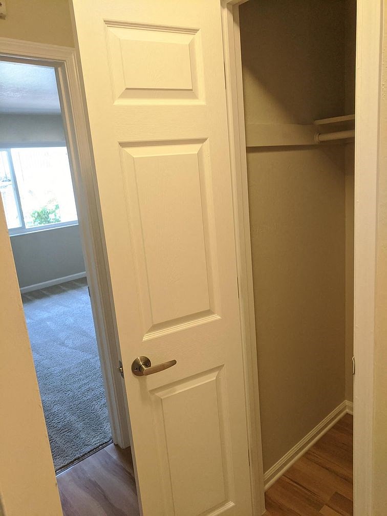 A white door with a handle is open.