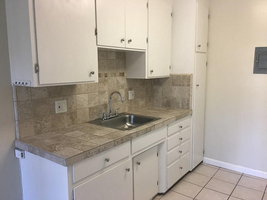 A kitchen with a sink and cabinets.