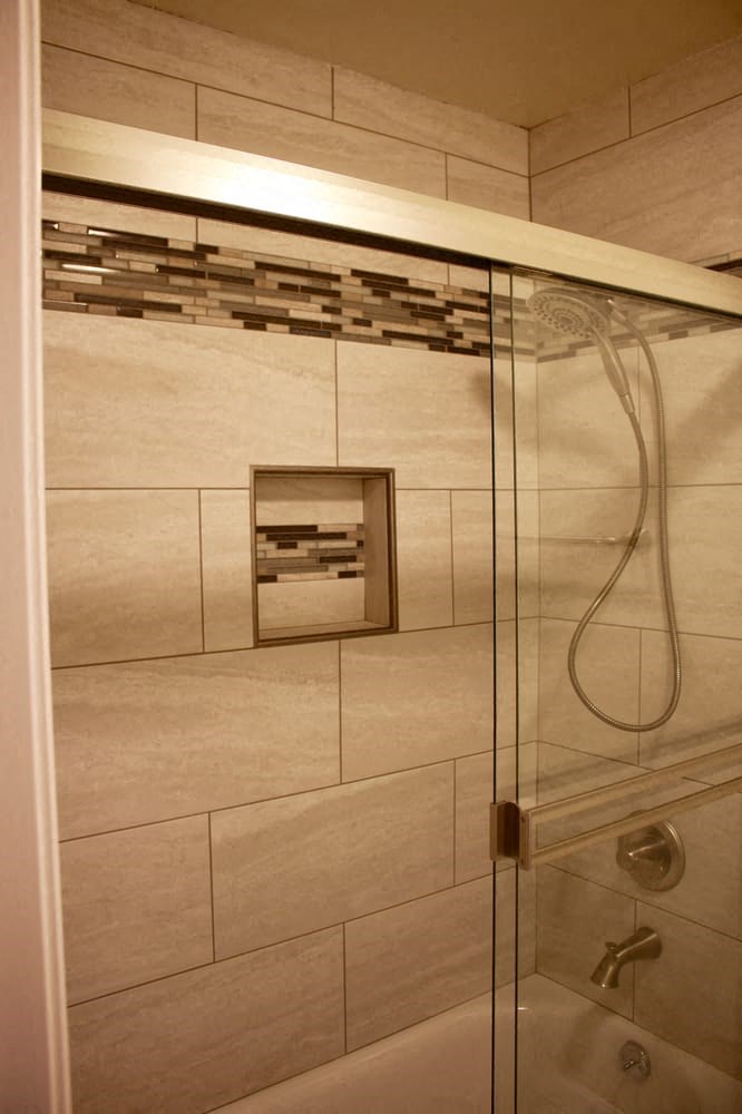 a bathroom with a shower with a glass door