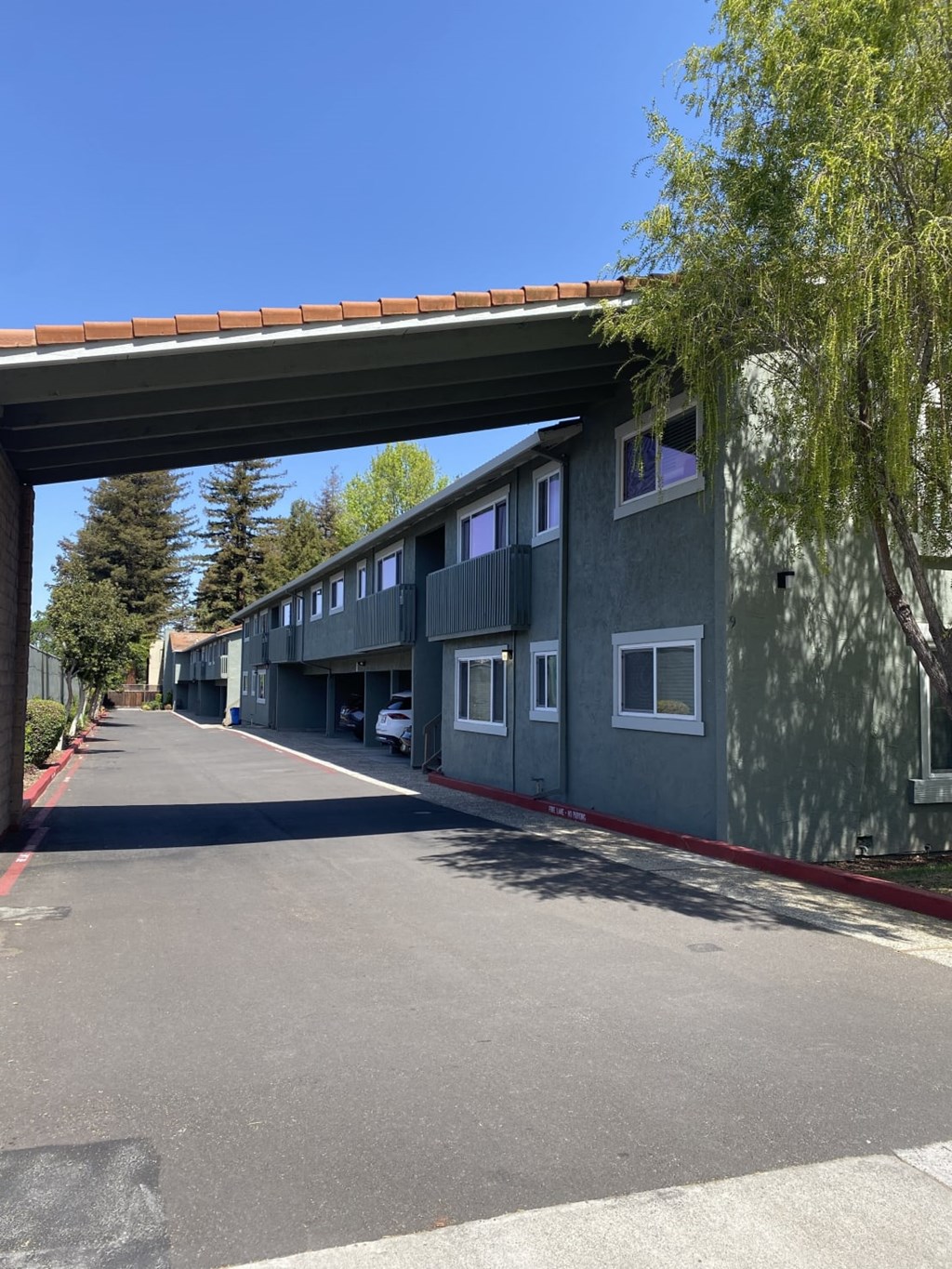 A row of houses under a bridge on a sunny day.