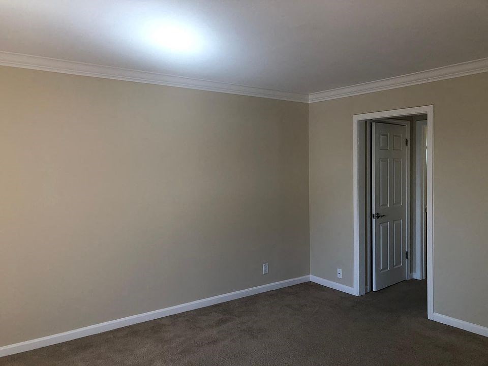 a empty room with a door to a hallway