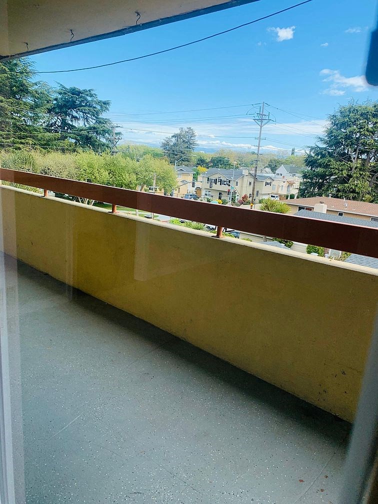 A view from a balcony looking out over a residential area.